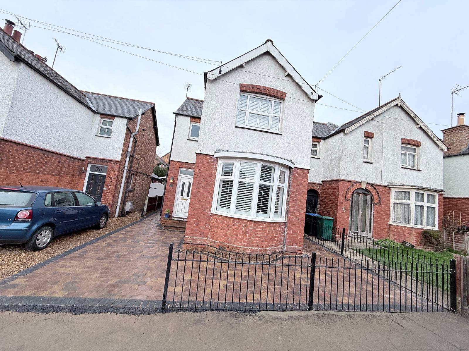 Front exterior view of the completed 52m² multi-size block paving driveway and modern metal fence installation in Market Harborough, Leicestershire by AAS Group Construction
