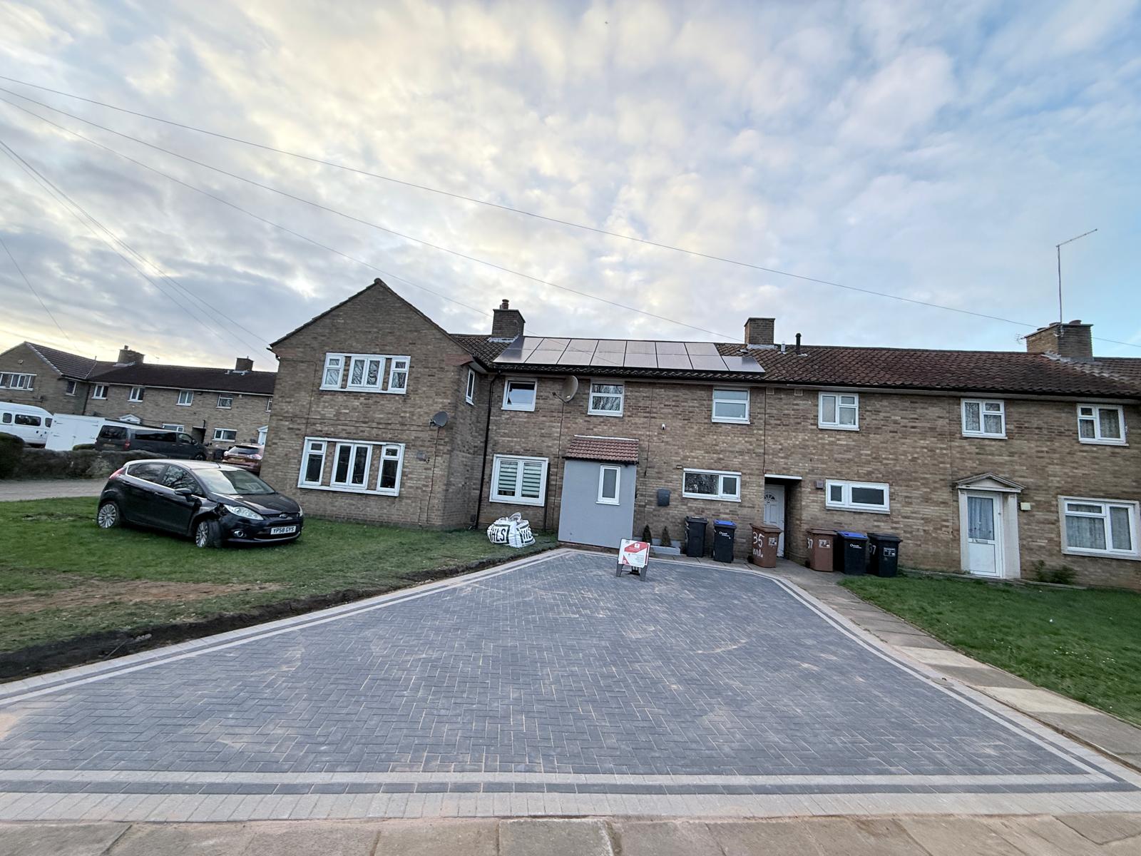 Frontal perspective of the completed 65m² charcoal block paving driveway featuring crisp border lines on Windbrush Way, Northampton by AAS Group Construction