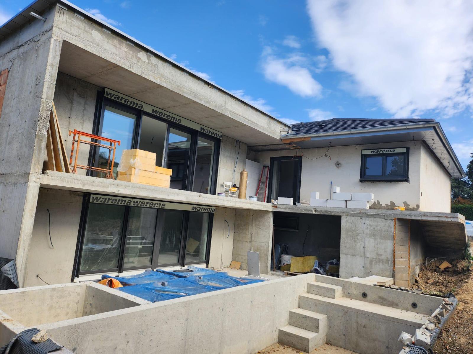 Exterior structure, reinforced concrete architecture, and glazing installation during a residential new build project by AAS Group Construction